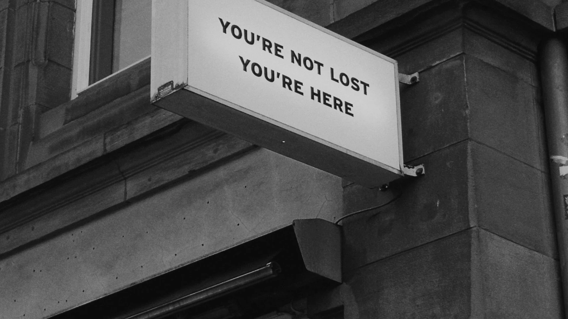 A building sign reading You're not lost, you're here